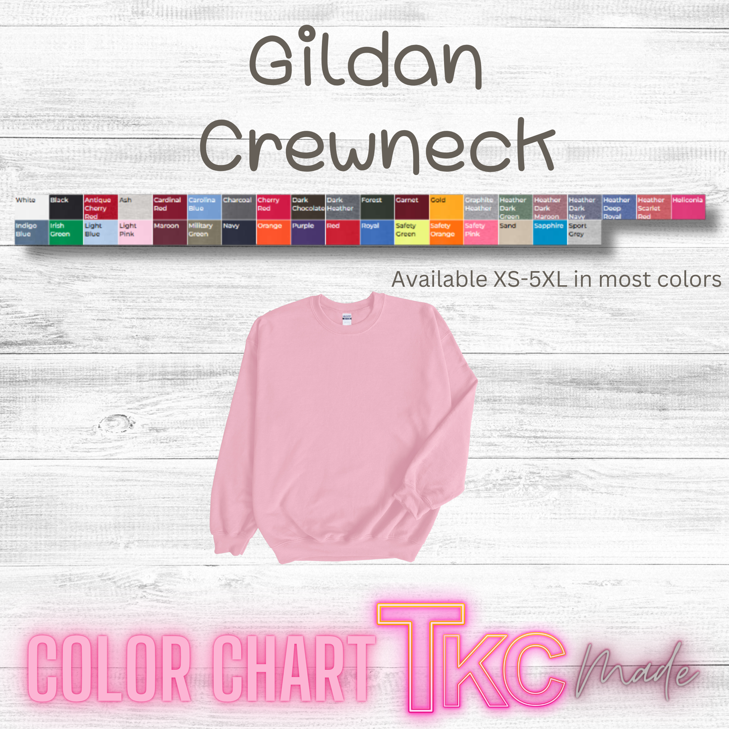 Pink Gildan crewneck sweatshirt with color chart on a light wooden background