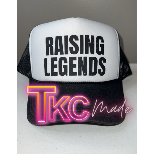 Trucker hat with 'RAISING LEGENDS' text and neon 'TKC made' design on a white background