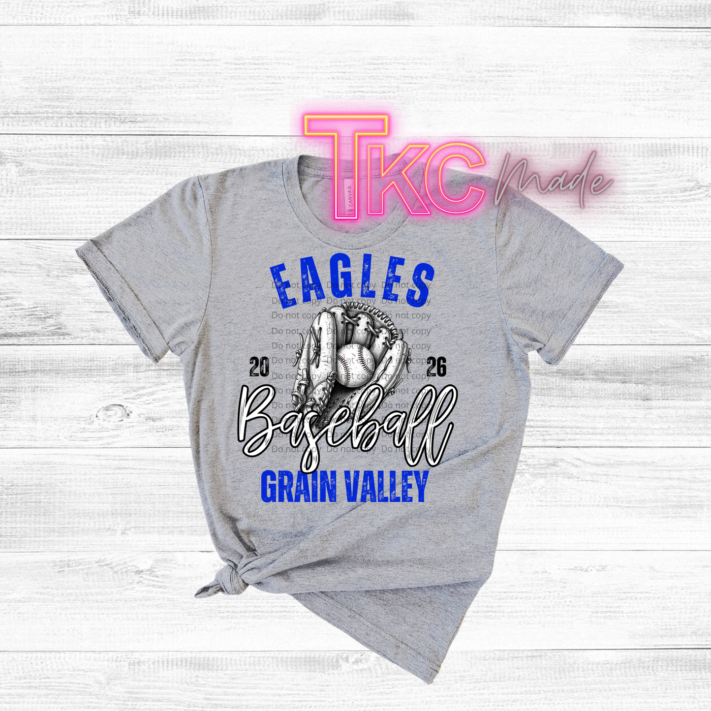 Gray t-shirt with 'Eagles Baseball Grain Valley' design on a wooden surface