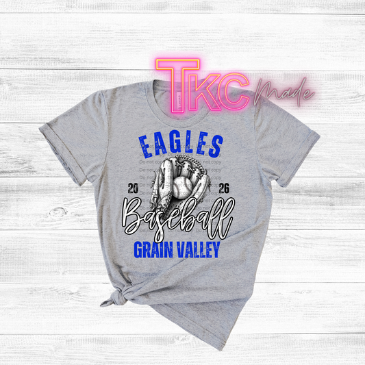 Gray t-shirt with 'Eagles Baseball Grain Valley' design on a wooden surface