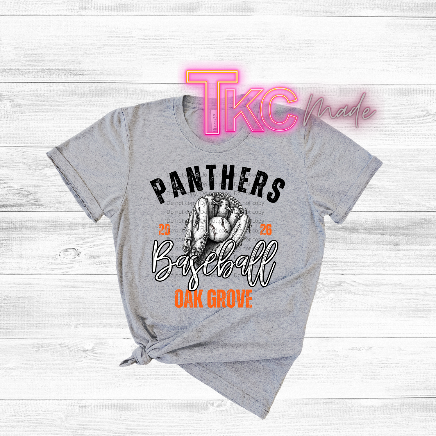 Gray t-shirt with 'Panthers Baseball Oak Grove' design on a wooden surface