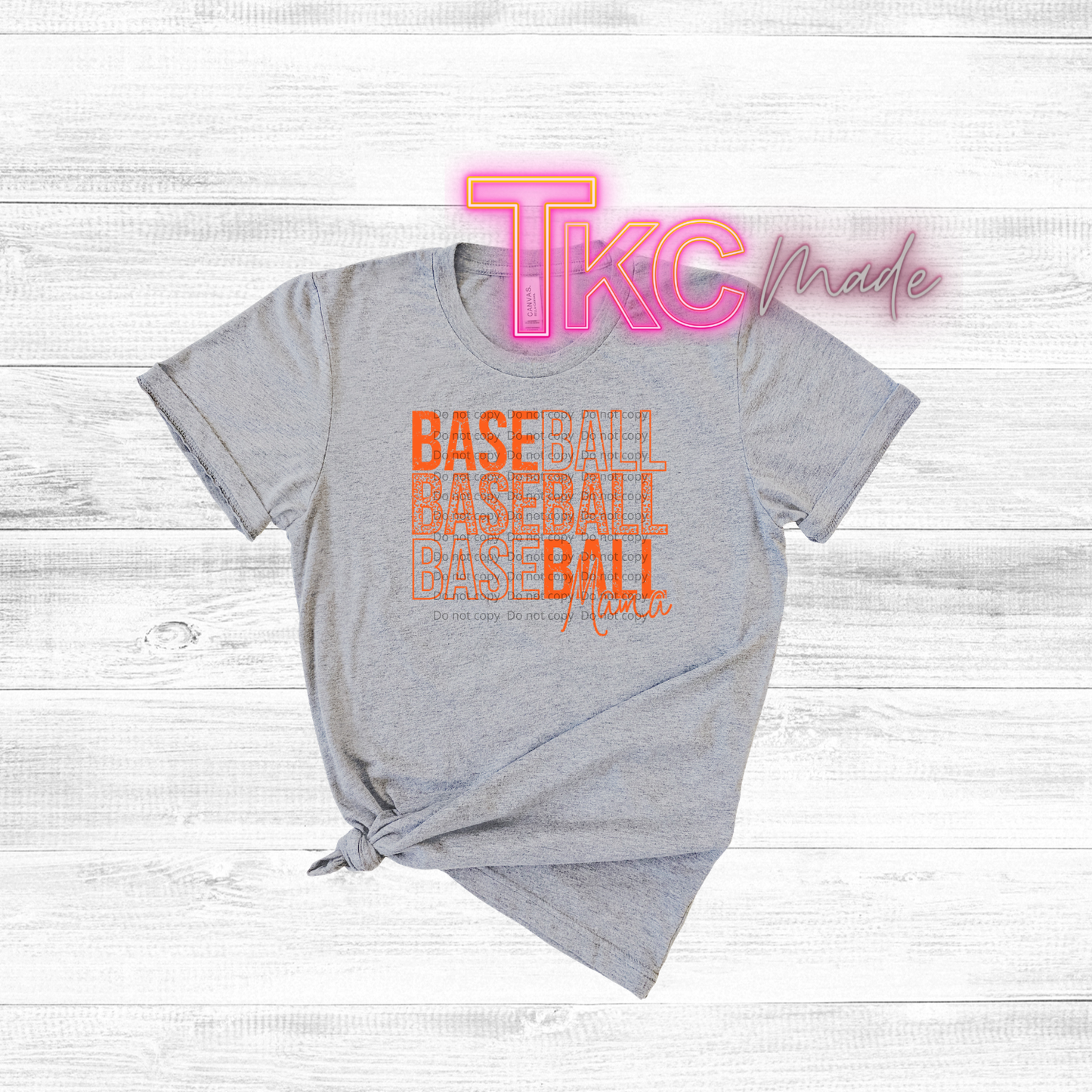 Gray t-shirt with 'TKC made' and 'BASEBALL' text on a wooden surface