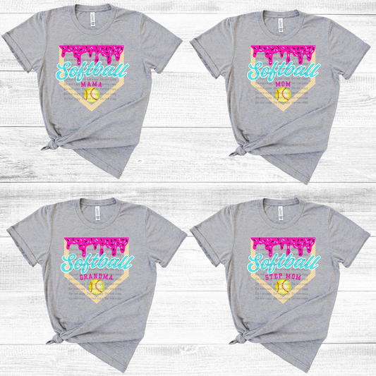 Four gray t-shirts with 'Softball Mom' and 'Softball Grandma' text on a wooden surface.