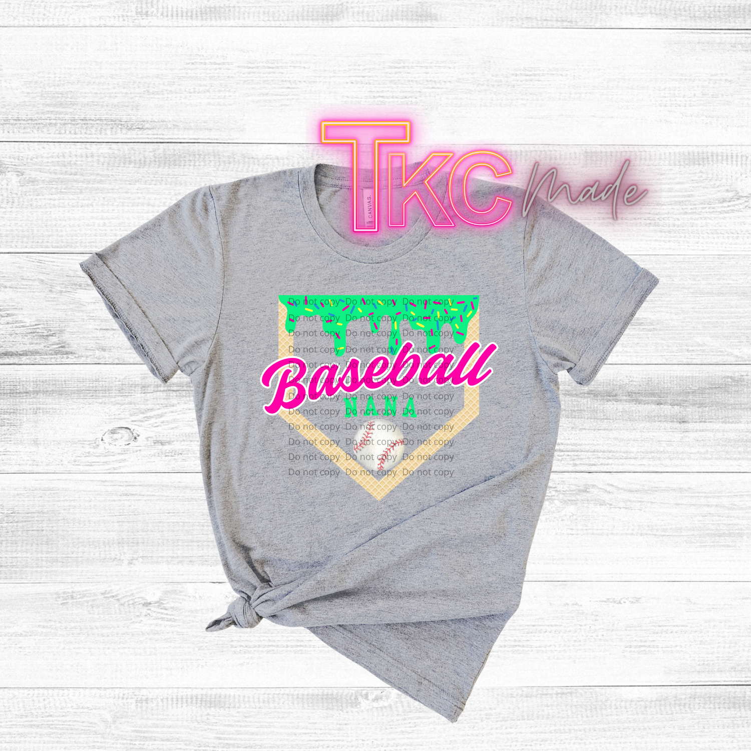 Gray t-shirt with colorful text and graphics on a wooden surface
