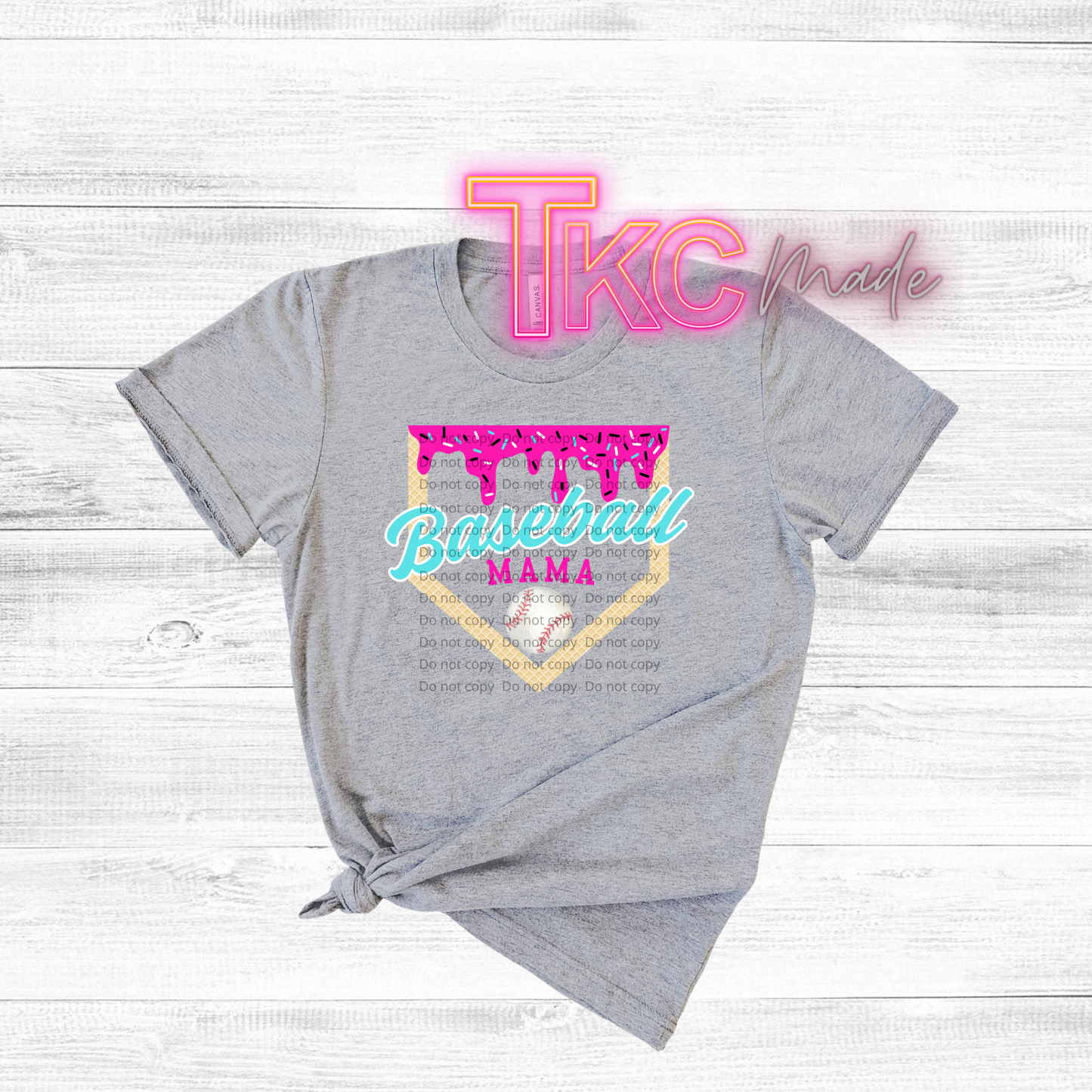 Gray t-shirt with 'Baseball Mama' design and 'TKC made' text on a light wooden background