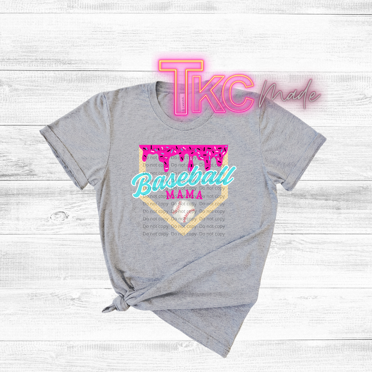 Gray t-shirt with 'Baseball Mama' design and 'TKC made' text on a light wooden background