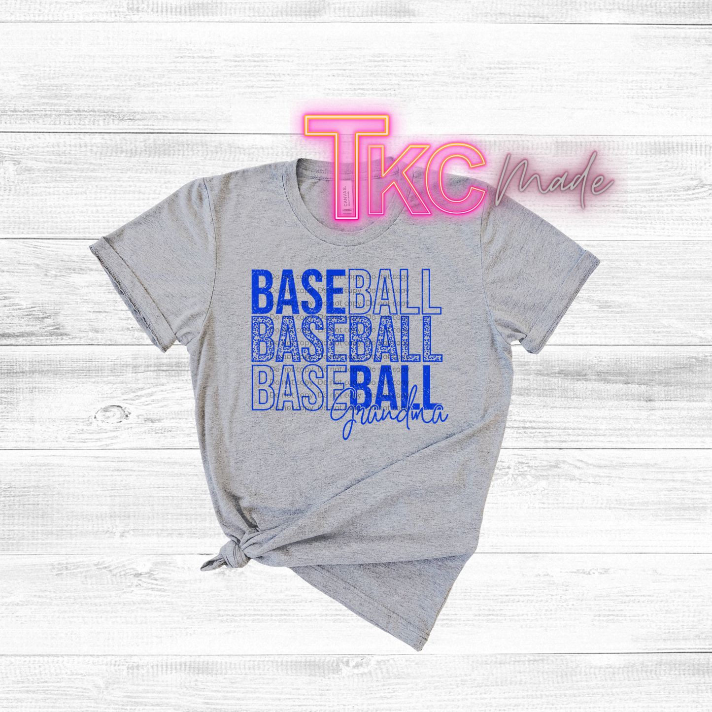 Gray t-shirt with 'BASEBALL BASEBALL BASEBALL' text and 'TKC made' branding on a light wooden background