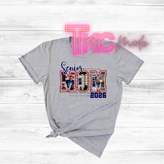 Gray t-shirt with 'Senior Mom 2026' design on a light wooden surface, featuring the text 'TkC Made'.