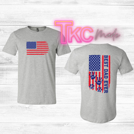 Gray t-shirt with American flag design on front and 'Best Dad Ever' text on back, custom kid or pets names on a light wooden background.