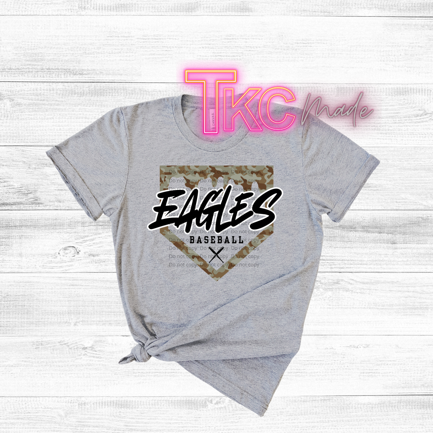 Gray t-shirt with 'Eagles Baseball' design and 'TKC made' text on a light wooden background