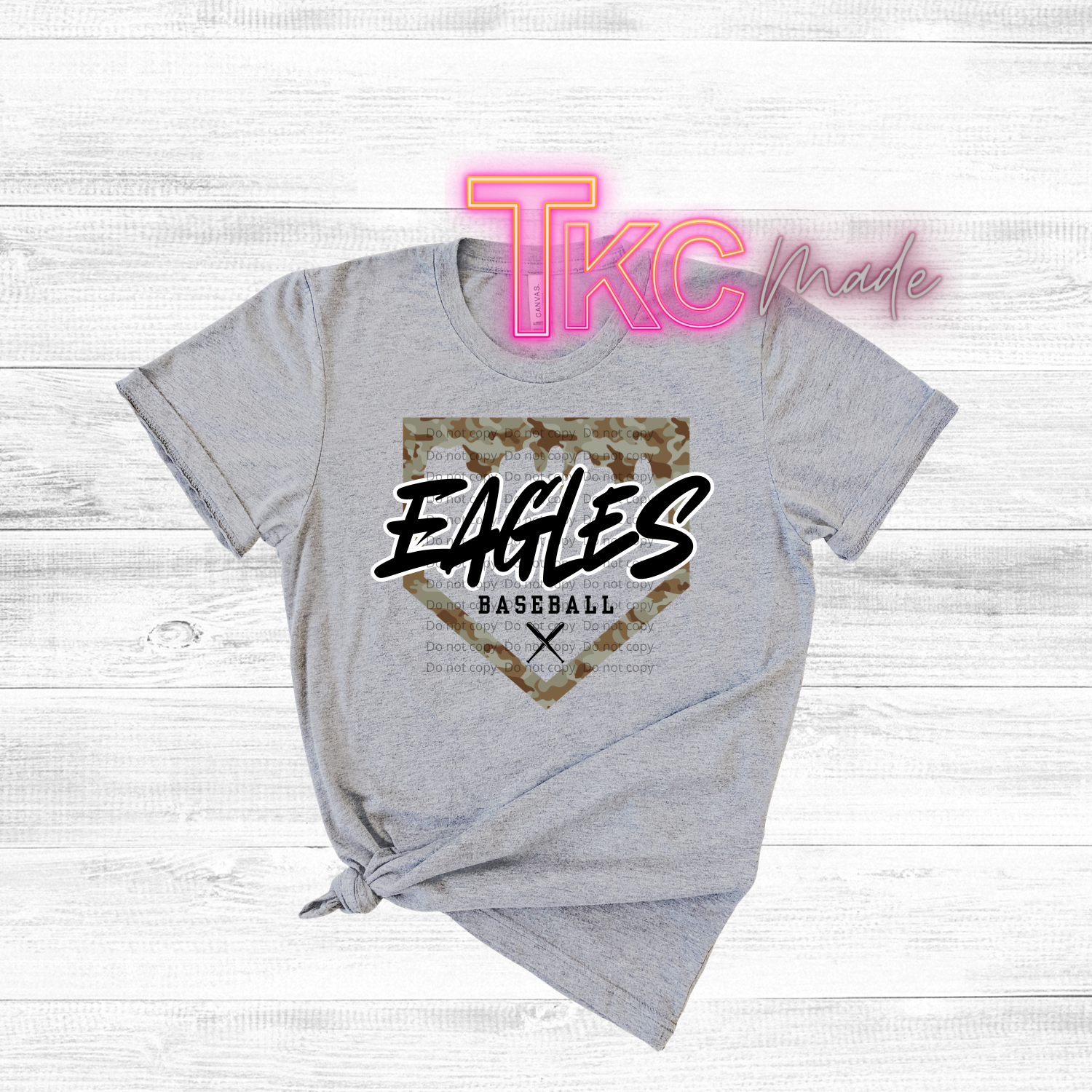 Gray t-shirt with 'Eagles Baseball' design and 'TKC made' text on a light wooden background