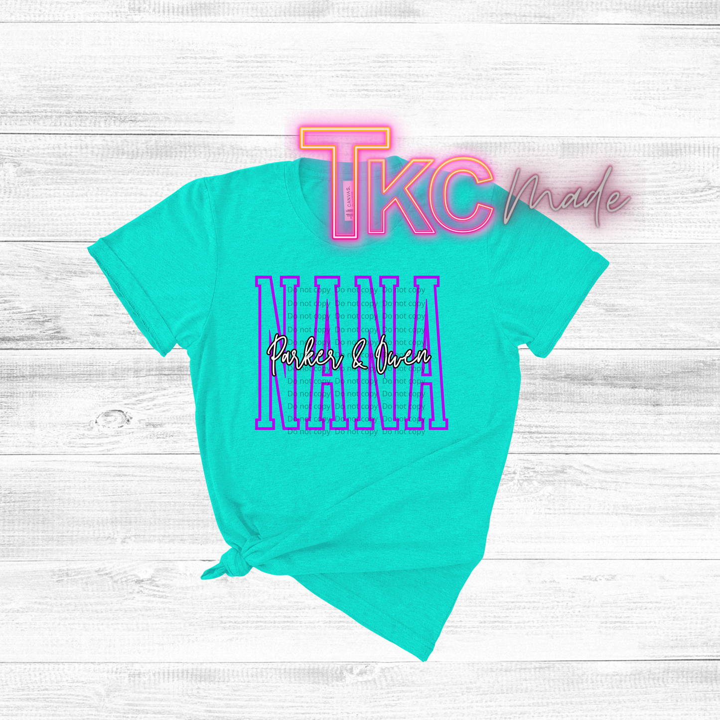 Turquoise t-shirt with 'TKC Made' and 'Nana Parker & Owen' text on a light wooden surface