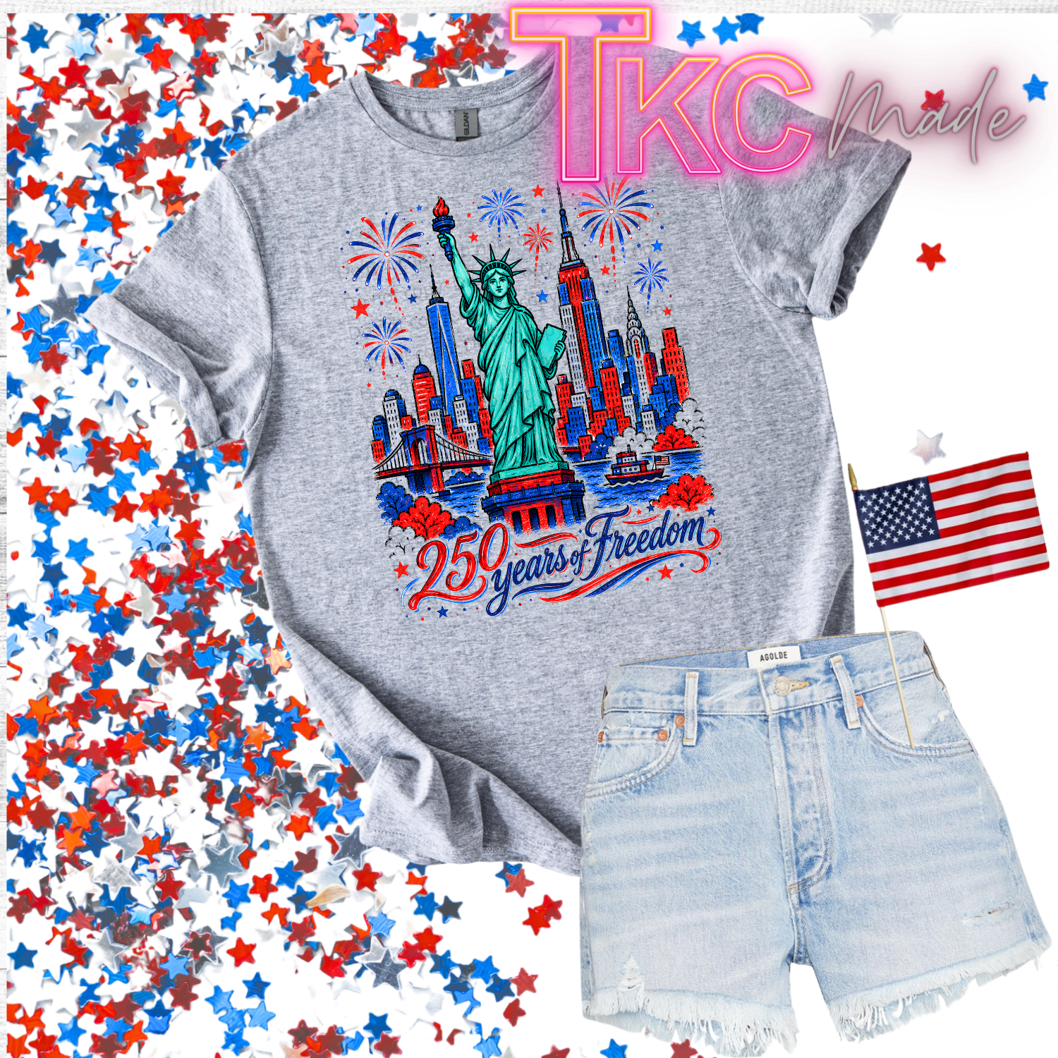 Gray t-shirt with Statue of Liberty design and denim shorts on a colorful confetti background