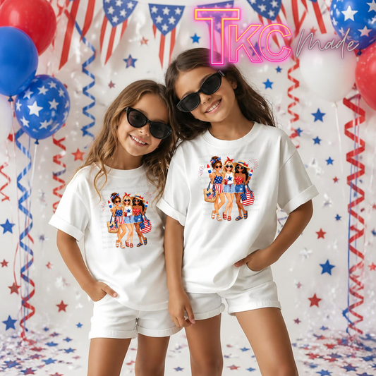 Two children wearing matching white t-shirts with a graphic design in front of a festive background with balloons and streamers.
