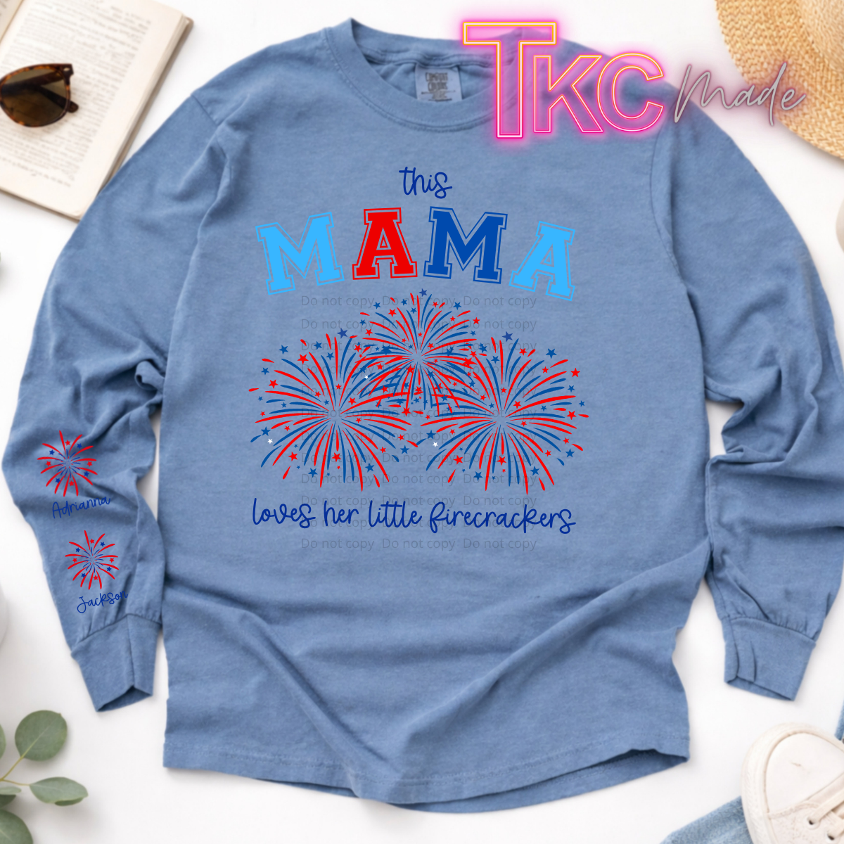 Blue long-sleeve shirt with red, white, and blue text and graphics on a white background