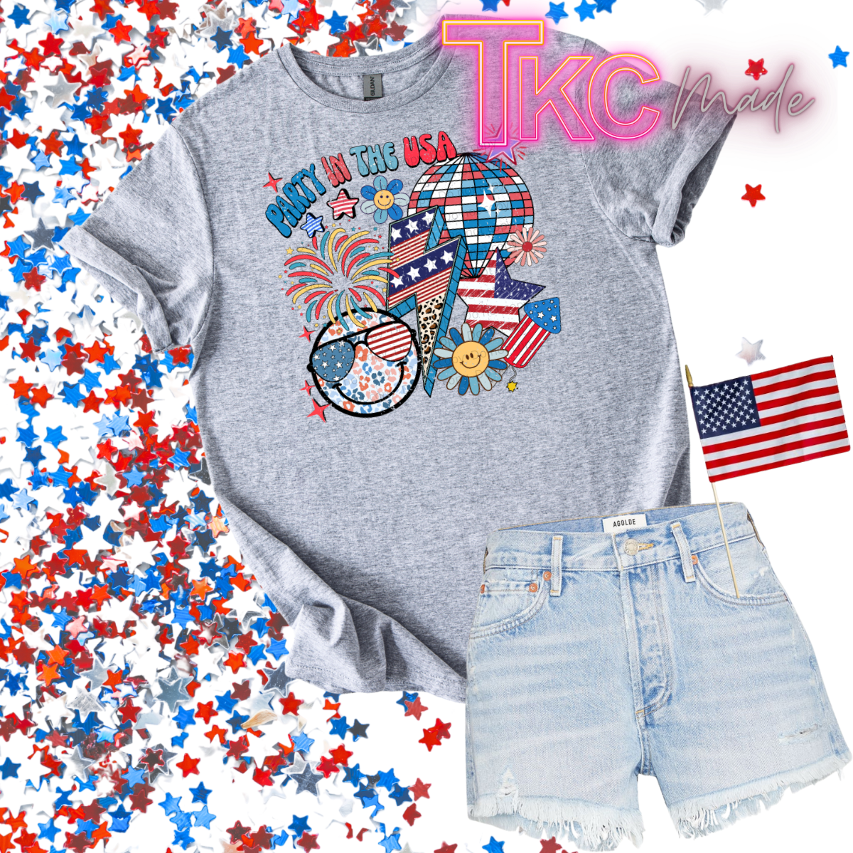 Gray t-shirt with patriotic design and denim shorts on a background with stars and an American flag.