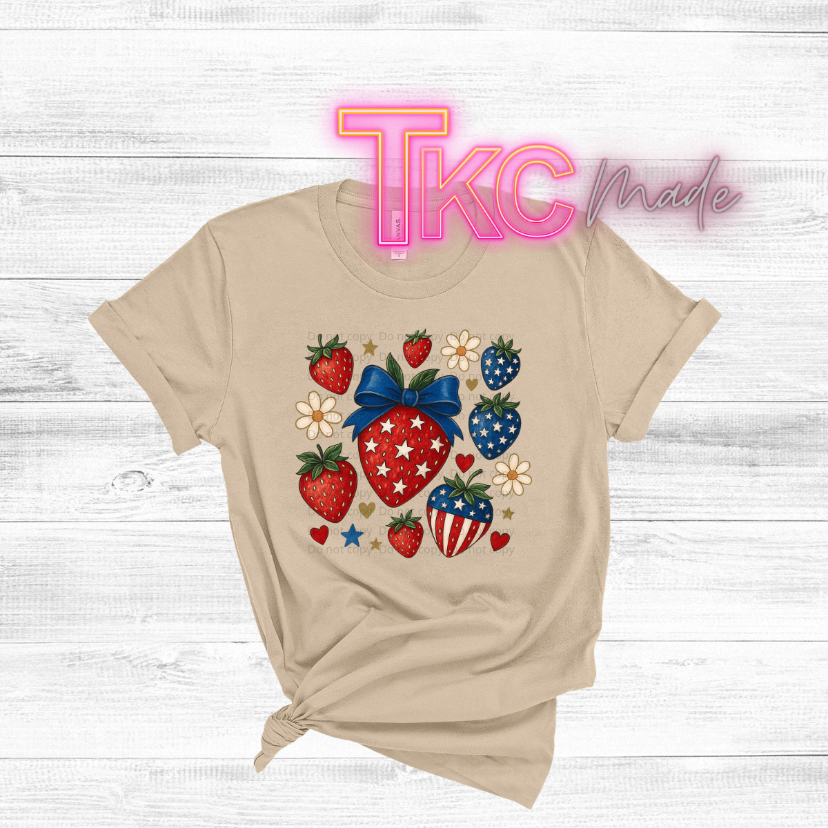 Beige t-shirt with colorful strawberry design on a light wooden background