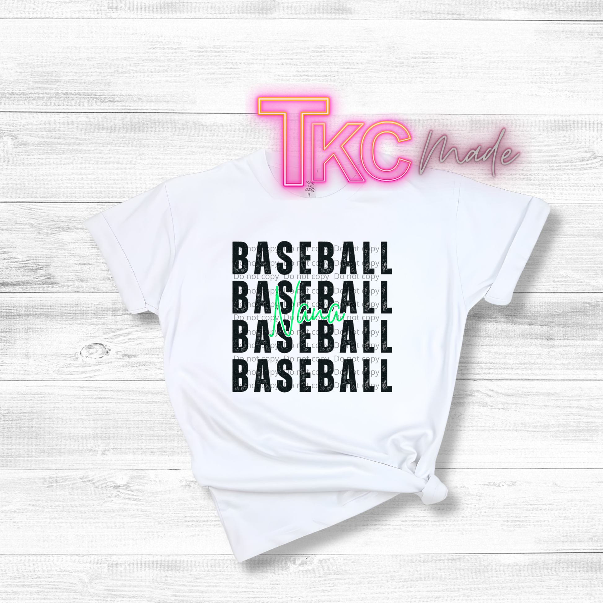 White t-shirt with 'BASEBALL BASEBALL BASEBALL BASEBALL' text and 'TKC made' branding on a light wooden background