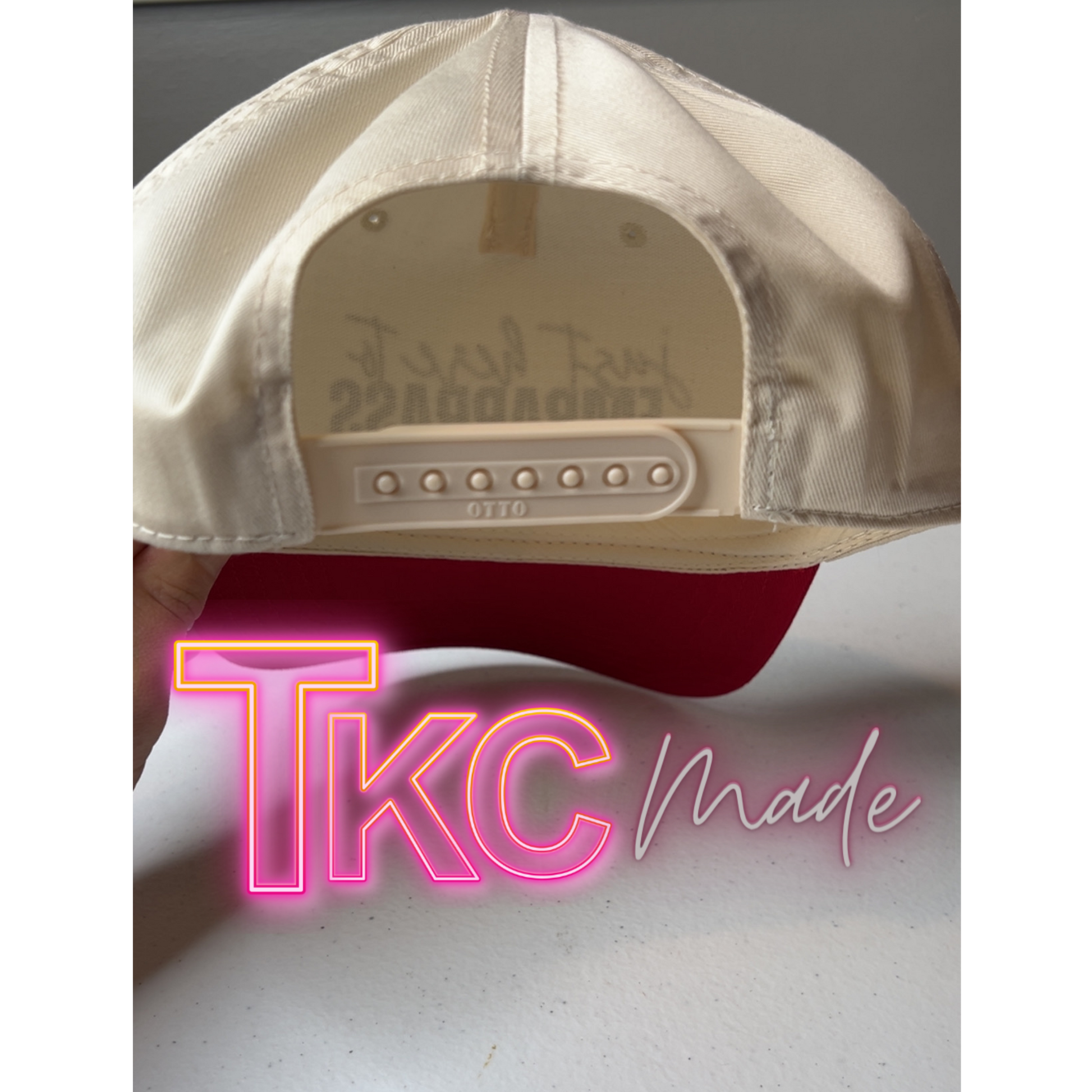 Beige cap with red interior and 'Tikc Made' text on a gray background