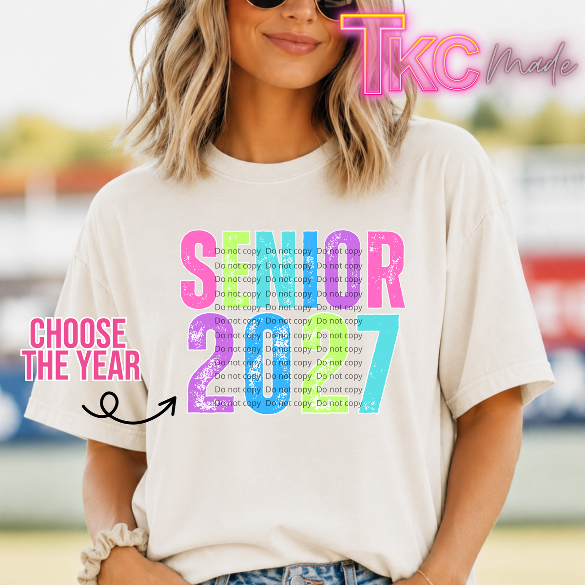 colorful "senior 2027" on an ivory white tee. choose the year