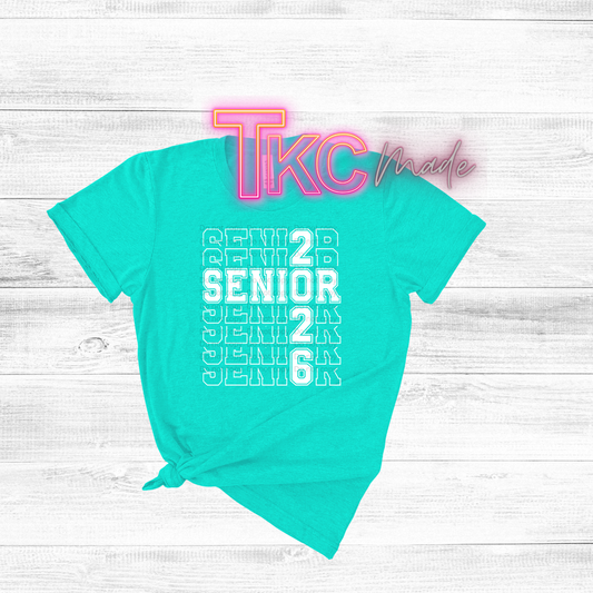 Turquoise t-shirt with 'Senior 2026' text on a white wooden background