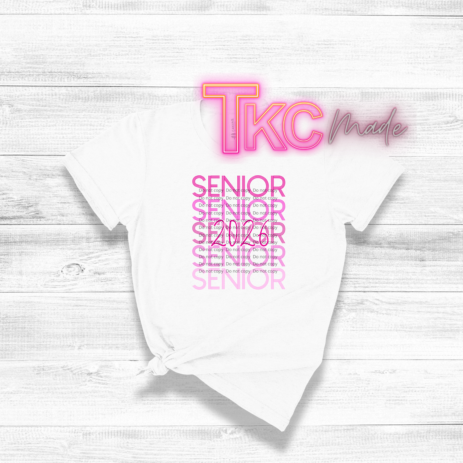 White t-shirt with 'TKC made' and 'Senior 2016' text on a light wooden surface