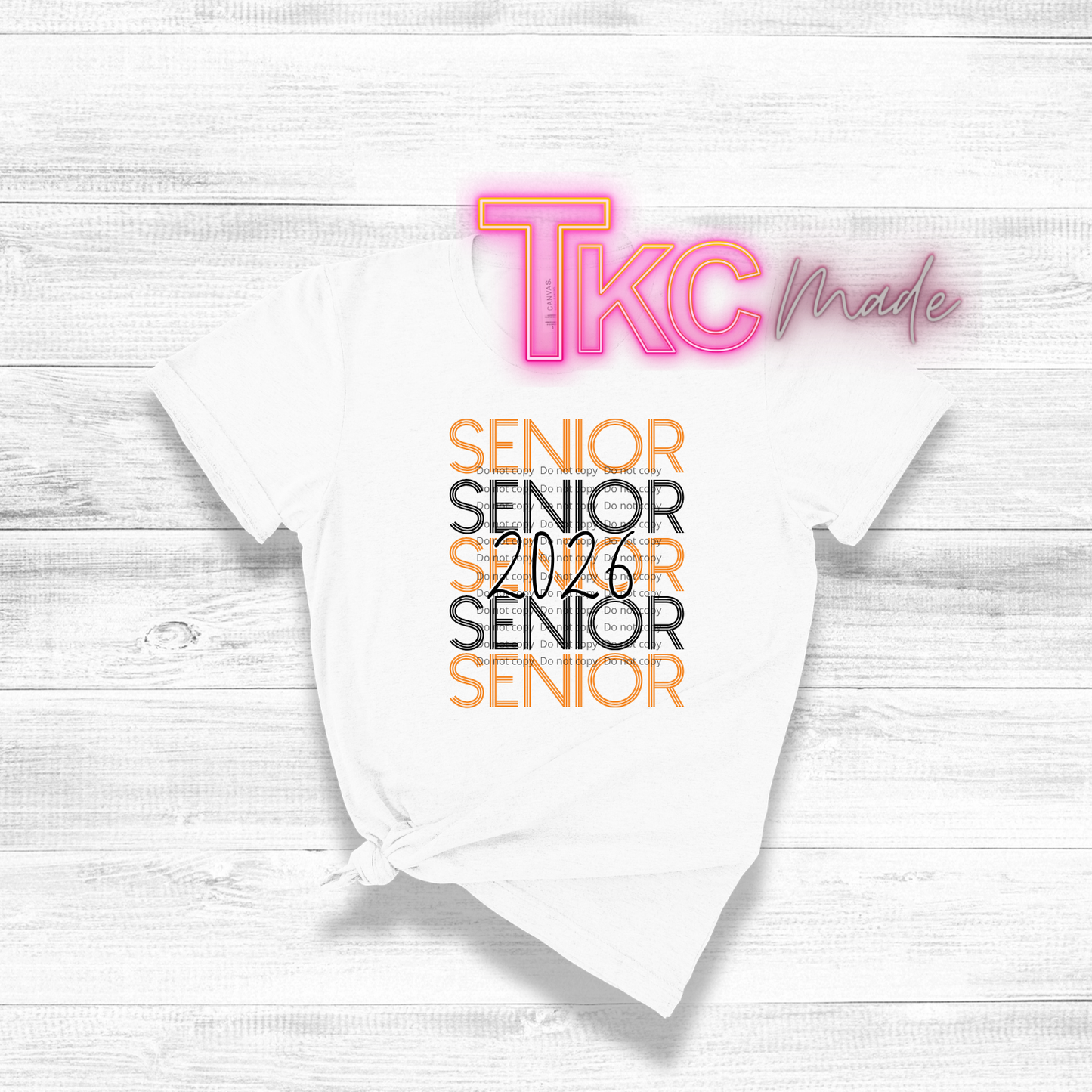 White t-shirt with 'Senior 2026' text and 'TKC made' branding on a light wooden surface.