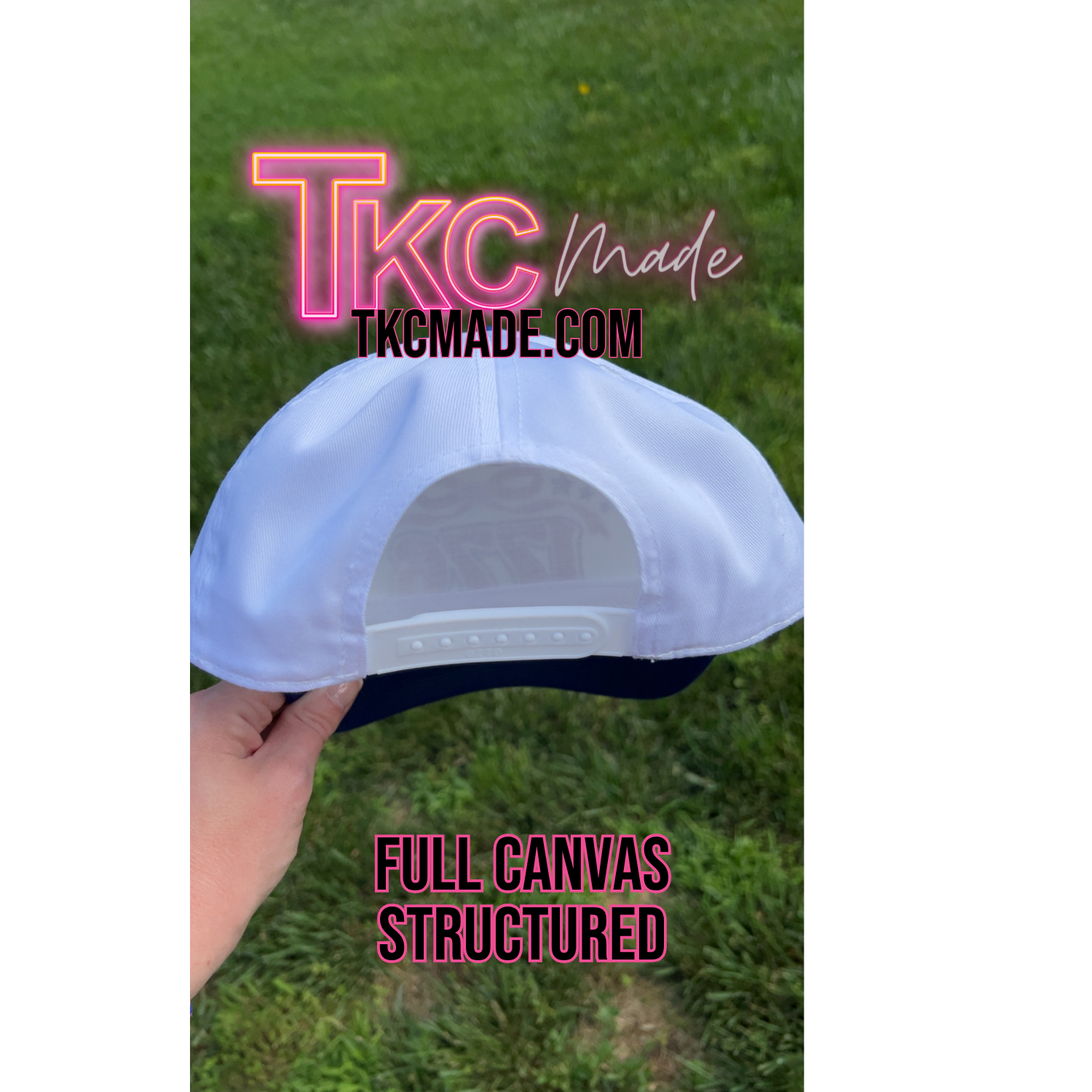 White cap with 'TKC Made' branding on a grass background
