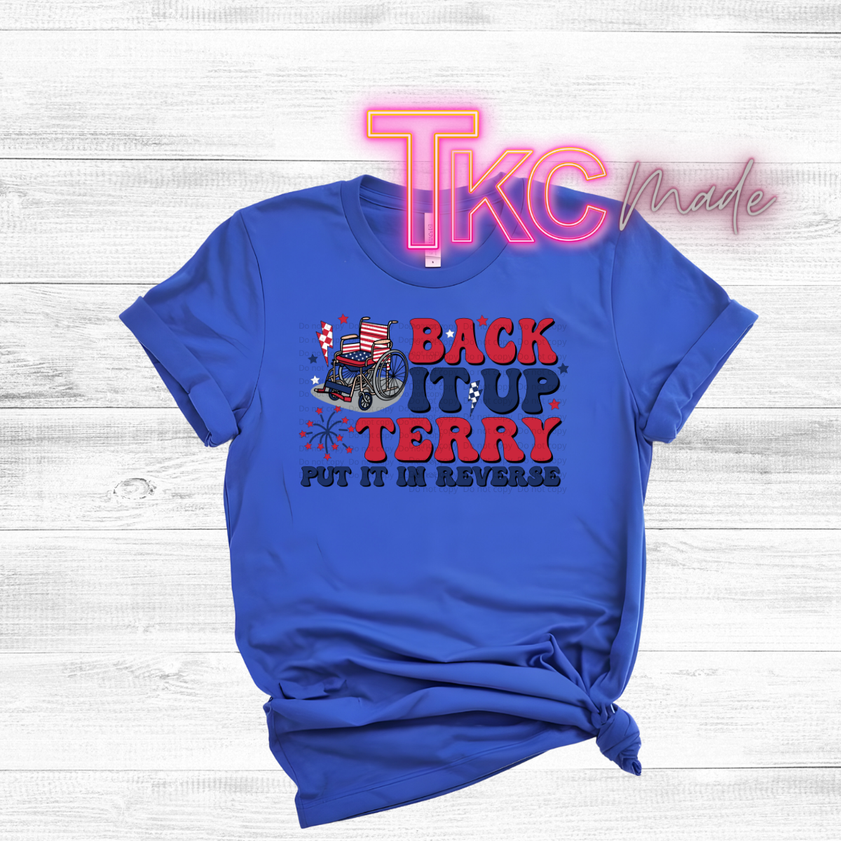 Blue t-shirt with graphic design and text on a light wooden background