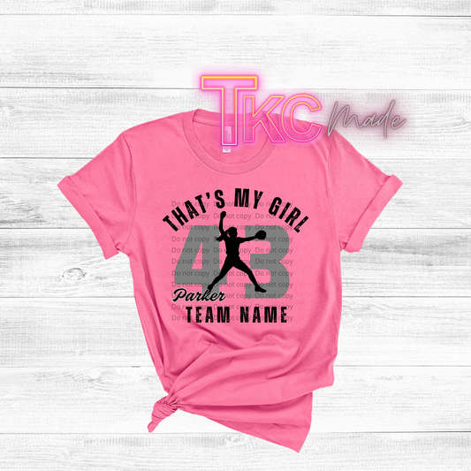 Pink t-shirt with basketball design and text on a light wooden background