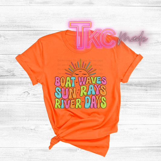 Orange t-shirt with colorful text design on a light wooden background