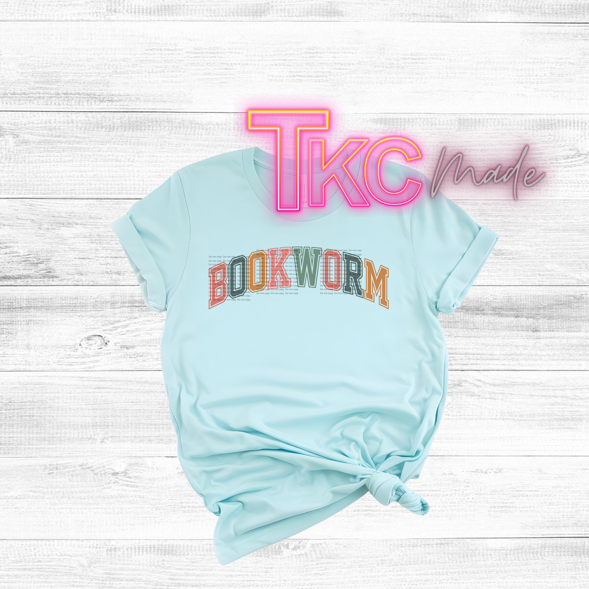 Light blue t-shirt with 'BOCKWORM' text on a white wooden background with 'TKC made' text.