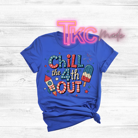 Blue t-shirt with colorful text and graphics on a white wooden background