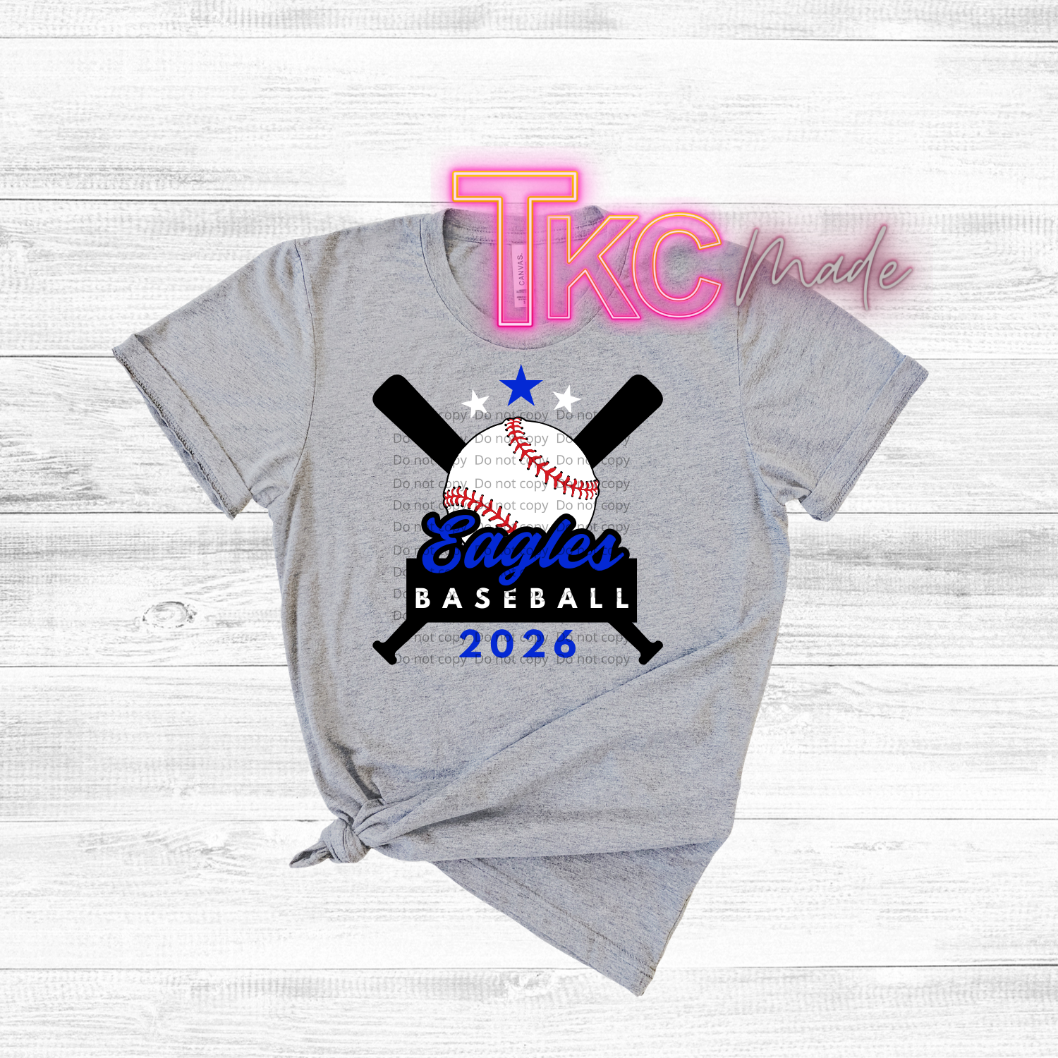 Gray t-shirt with Eagles baseball design and 'TKC made' text on a wooden surface