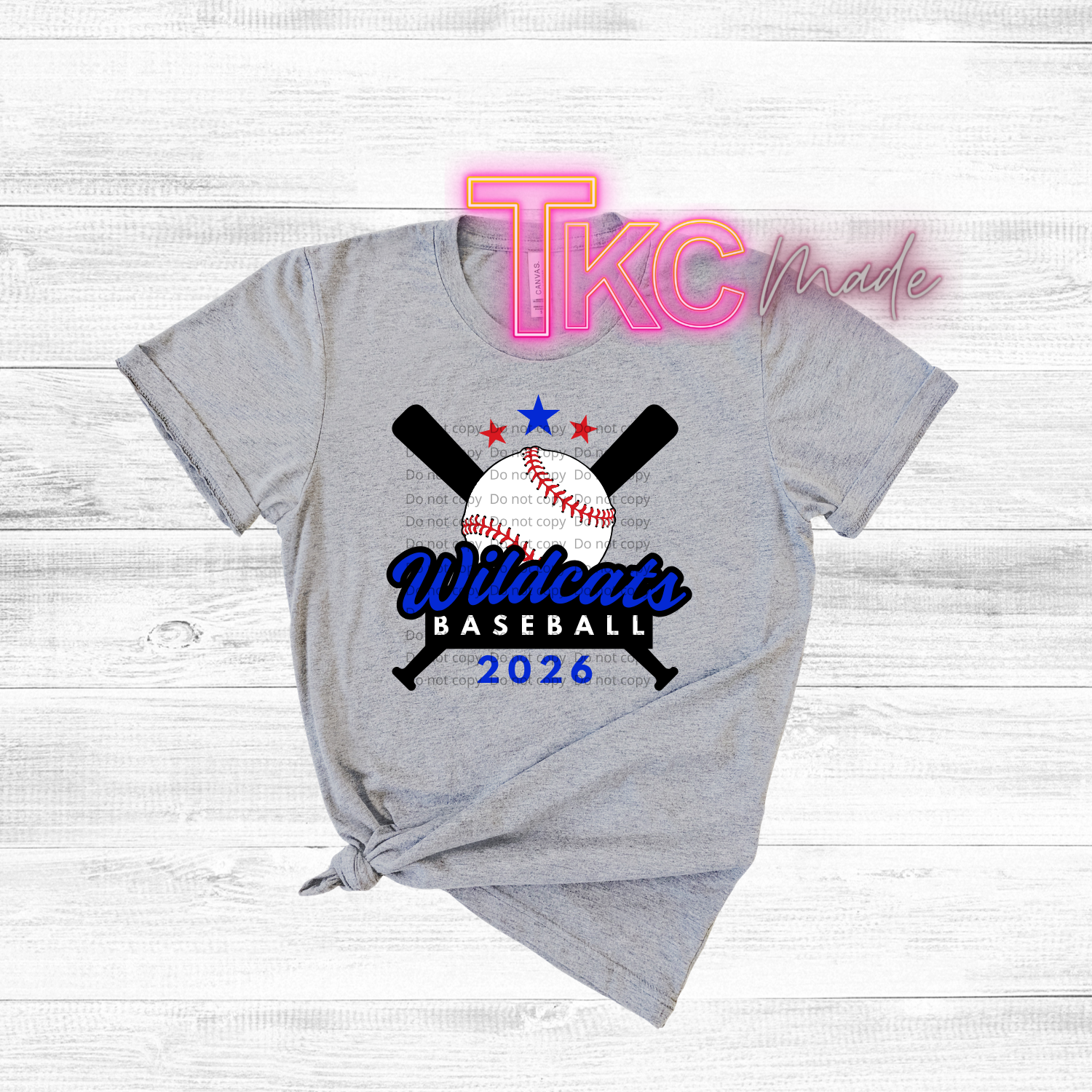 Gray t-shirt with Wildcats Baseball 2026 design on a white wooden background