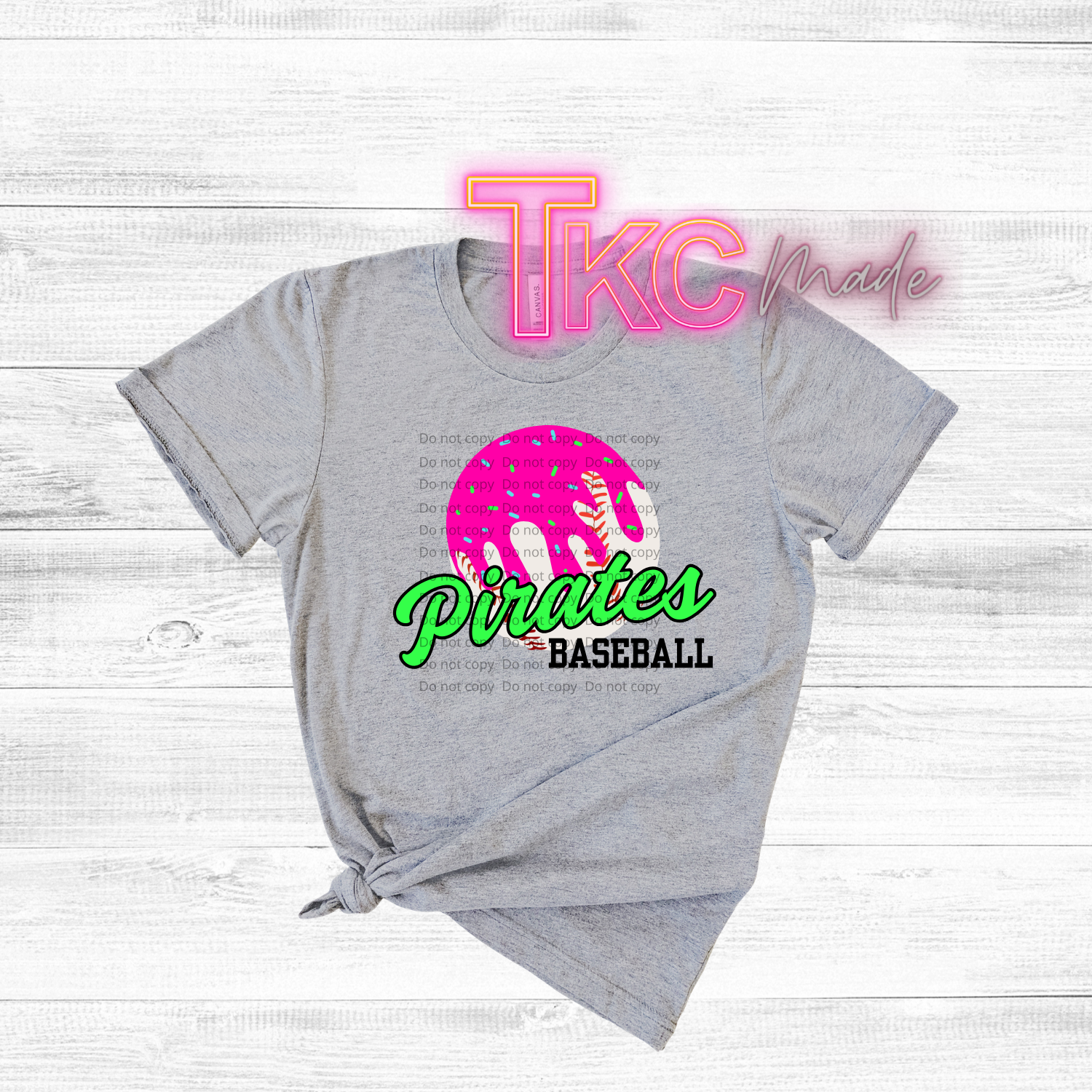 Gray t-shirt with 'Pirates Baseball' design and 'TKC made' text on a light wooden background