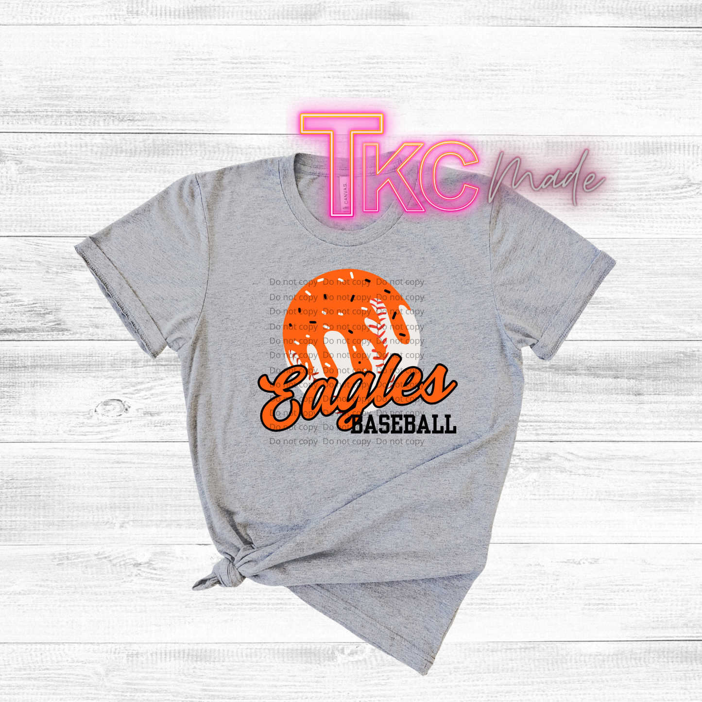 Gray t-shirt with orange and black 'Eagles Baseball' design on a light wooden background