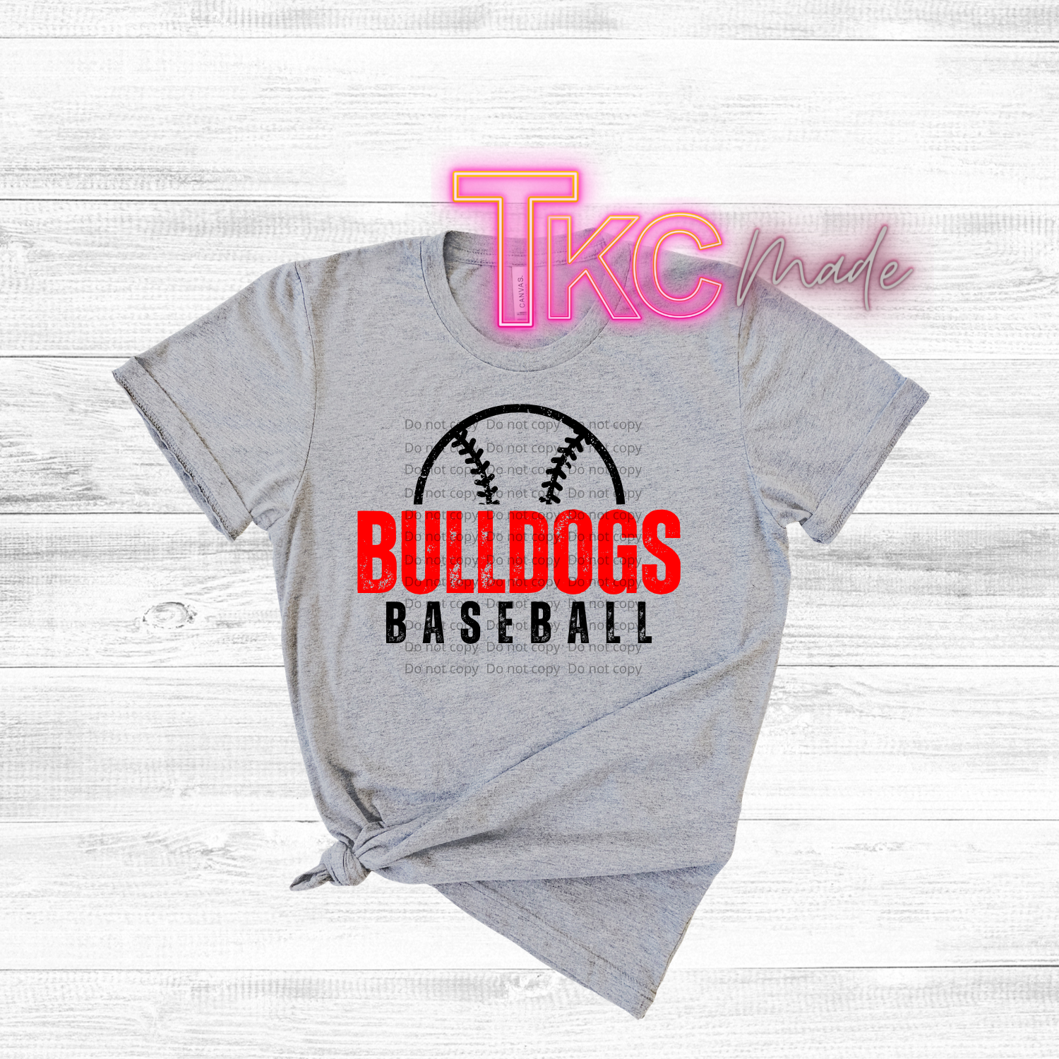 Gray t-shirt with 'Bulldogs Baseball' text and logo on a white wooden background
