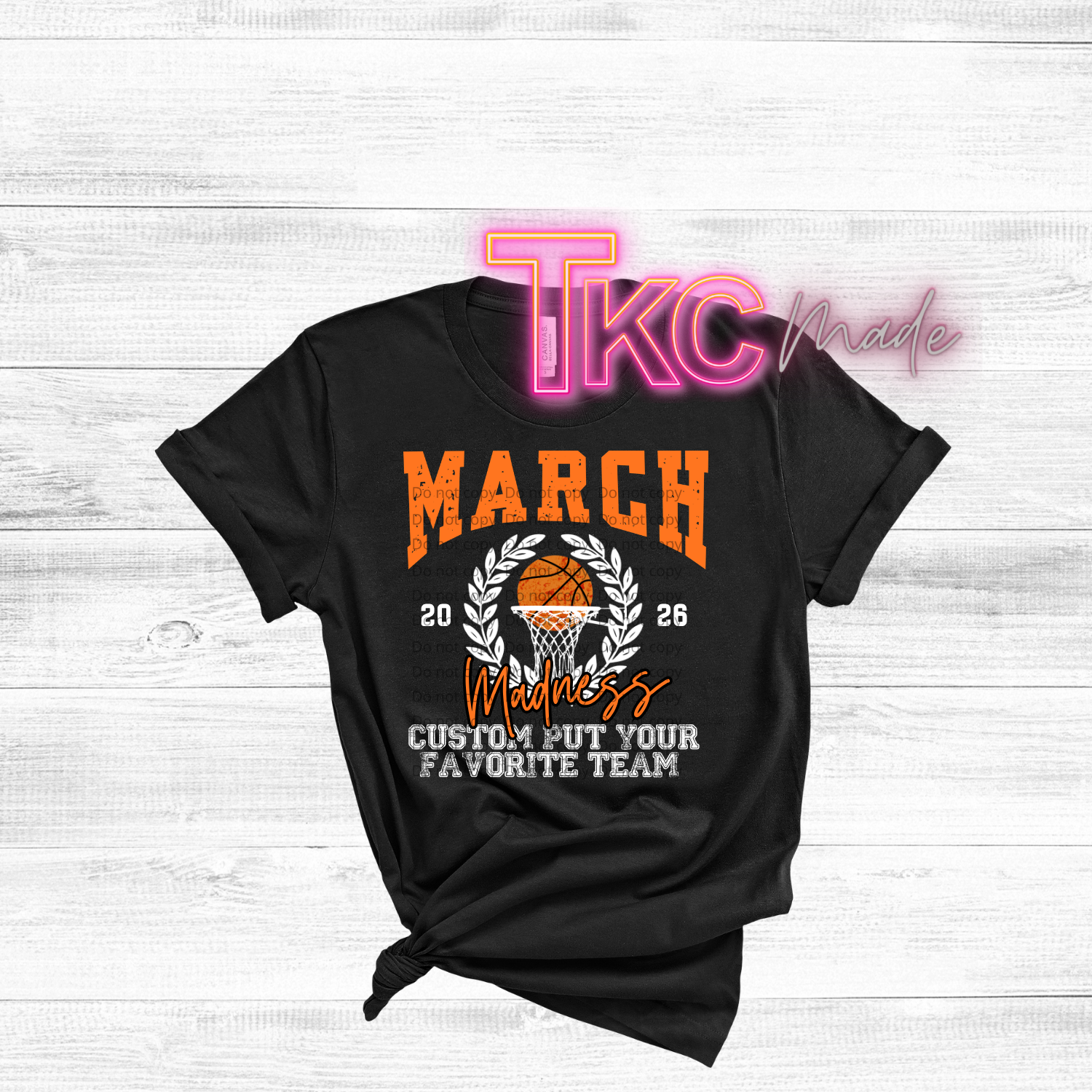 Black t-shirt with basketball design and text on a white wooden background