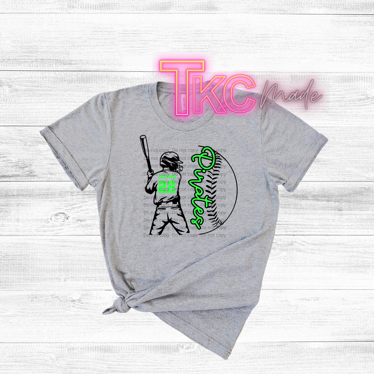 Gray t-shirt with a graphic of a baseball player and text on a white wooden background