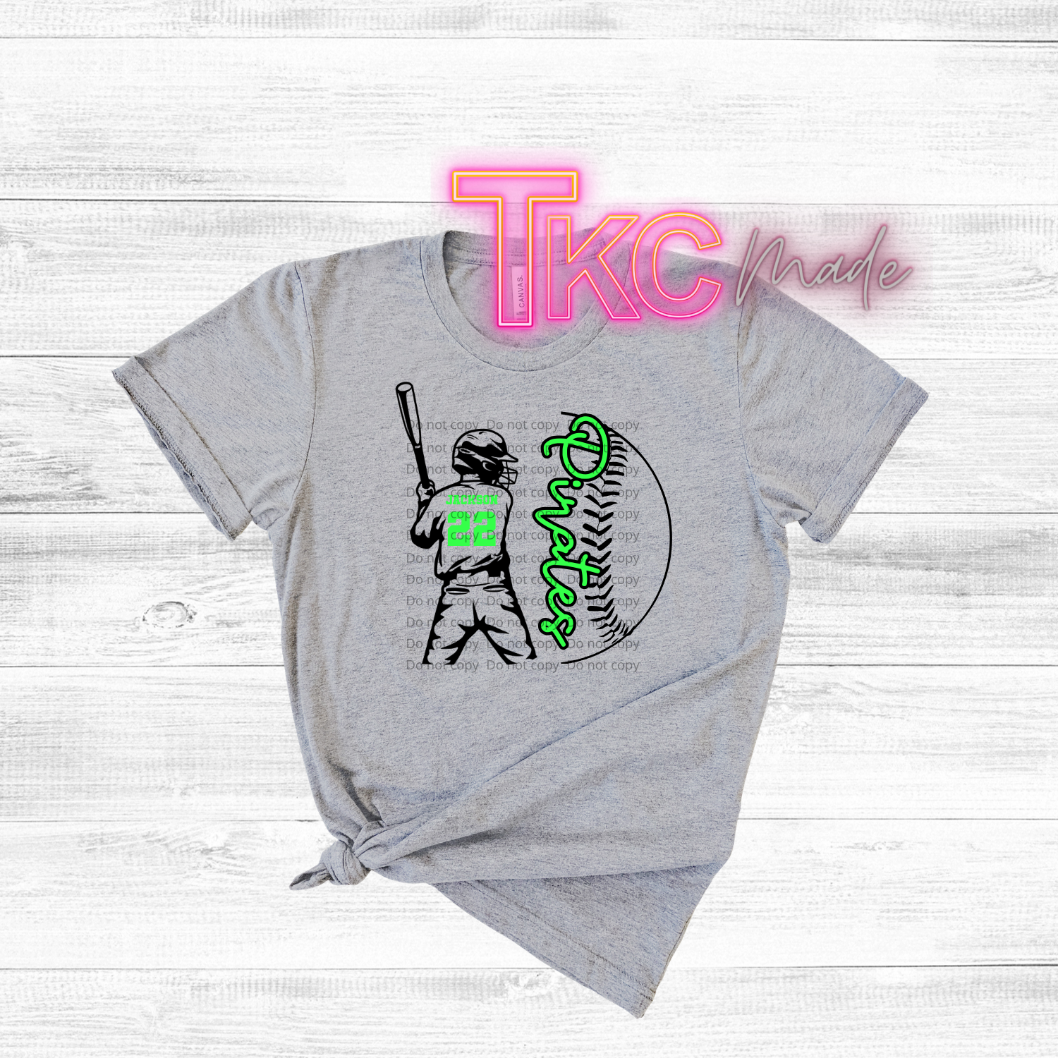 Gray t-shirt with a graphic of a baseball player and text on a white wooden background