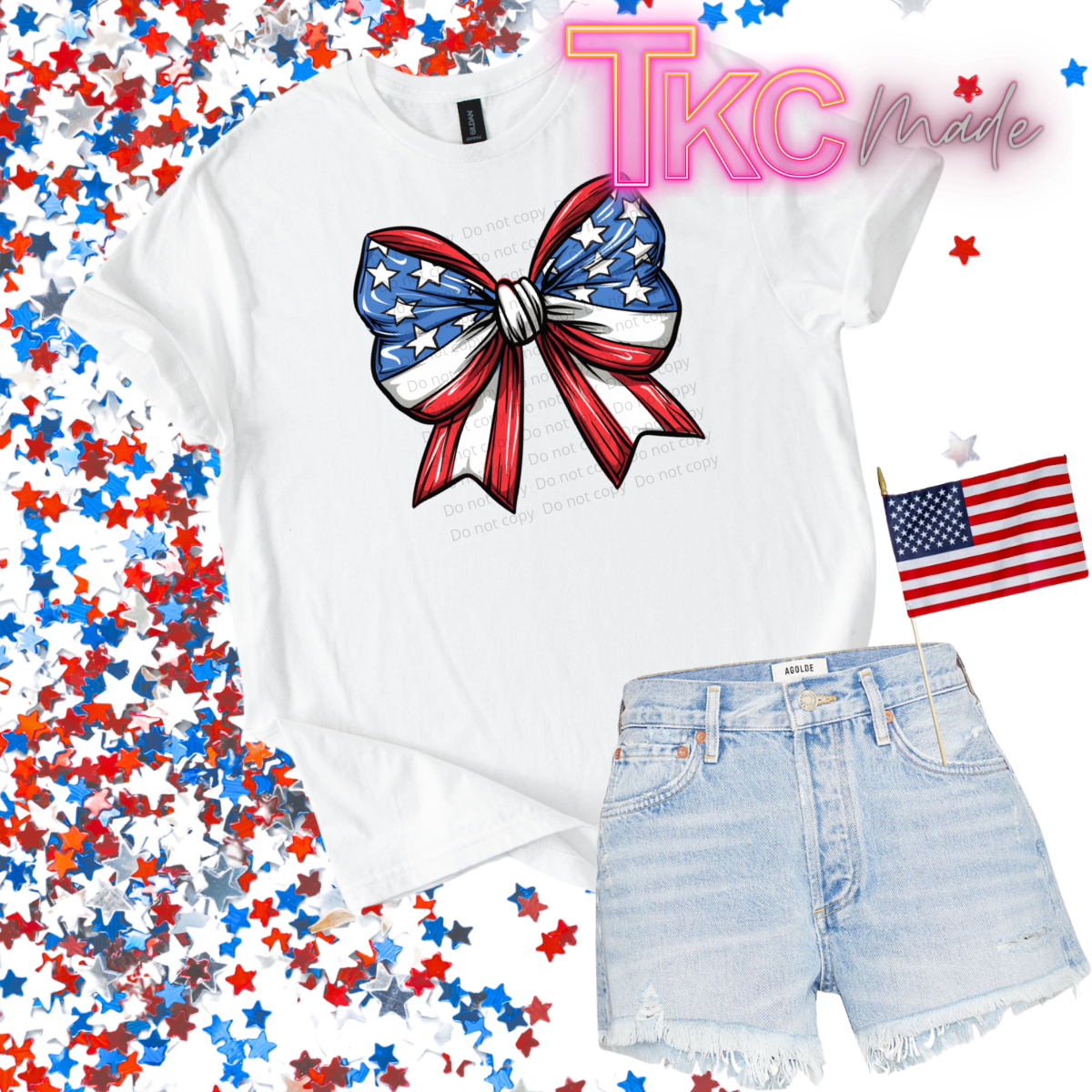 White t-shirt with American flag bow design and denim shorts on a colorful star background.