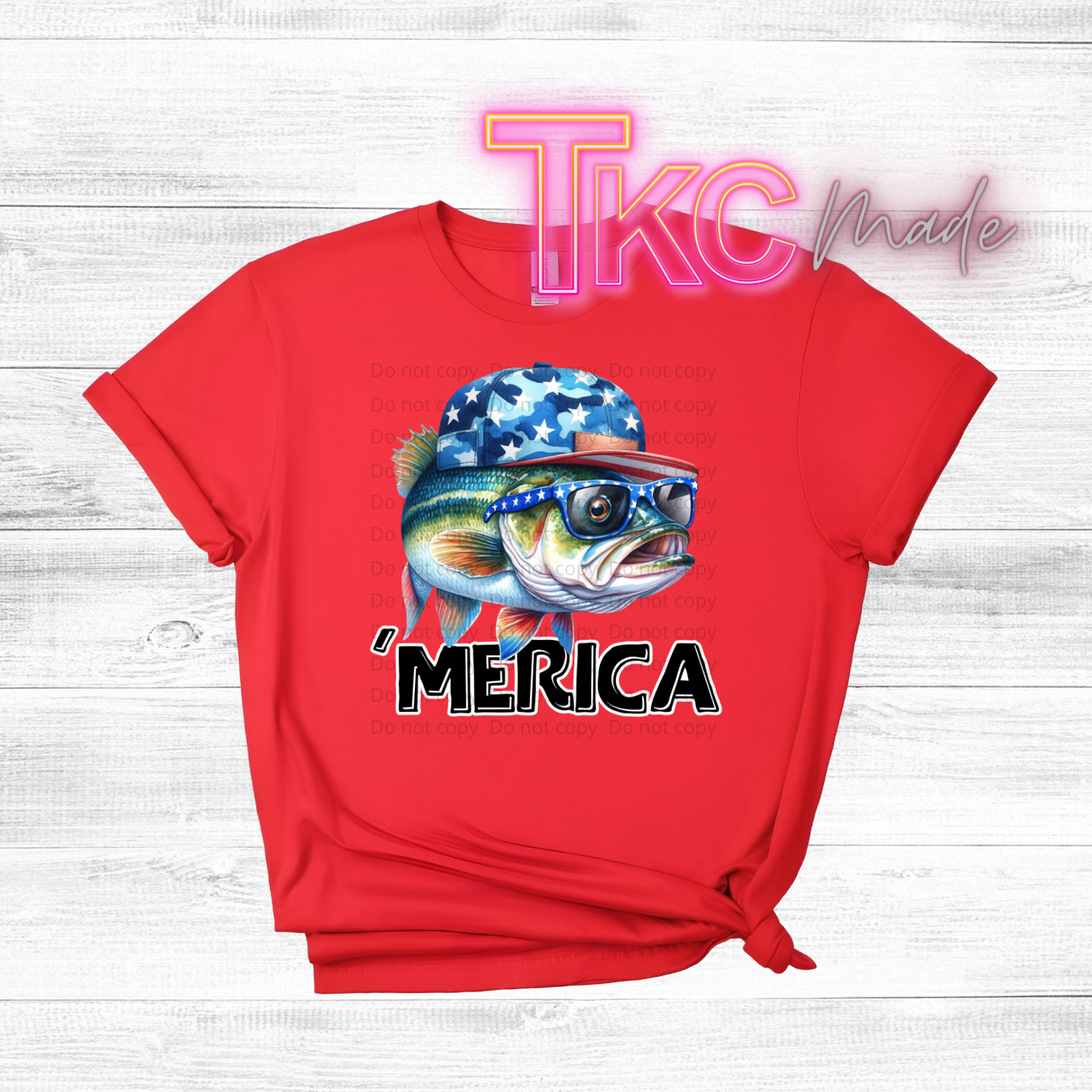 Red t-shirt with a fish graphic wearing an American flag hat and 'MERICA text on a wooden surface.
