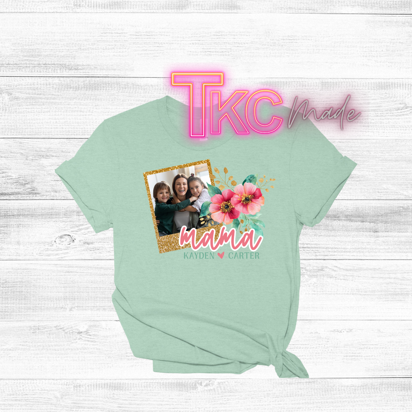 sage green t-shirt with a photo of a family and floral design on a white wooden background.
