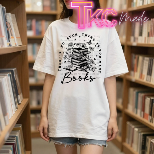 Person wearing a white t-shirt with a book-themed design in a library setting