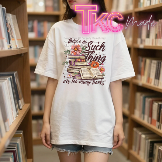 Person wearing a white t-shirt with a book-themed design in a library setting