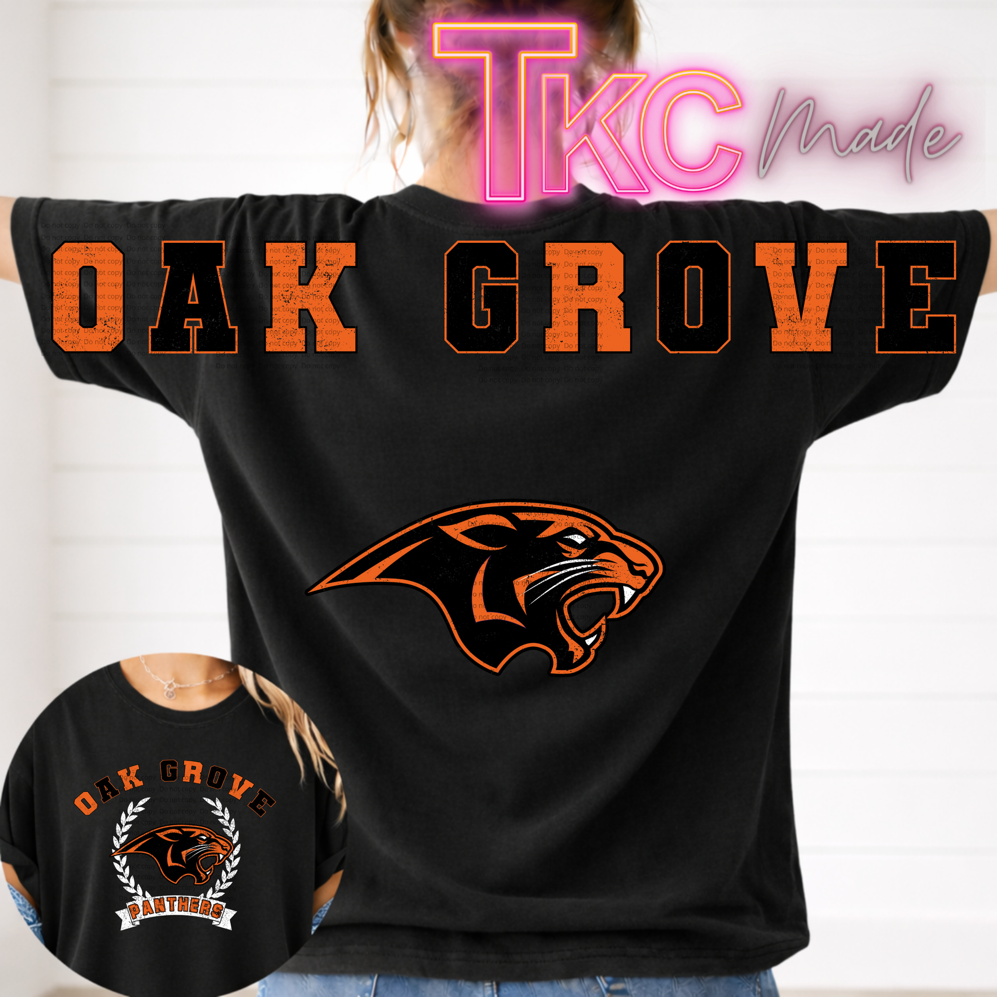 A person wearing a black short-sleeve T-shirt with large orange and black 'OAK GROVE' lettering across the back and a large orange panther graphic below. A circular inset shows the front of the shirt with a smaller version of the same design.