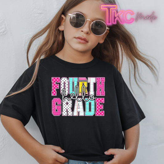 A young girl with long light brown hair wearing round sunglasses and a black graphic t-shirt that reads 'FOURTH Grade' in pink, white, and light blue patterned letters. A 'TKC Made' watermark is visible in the top right corner.