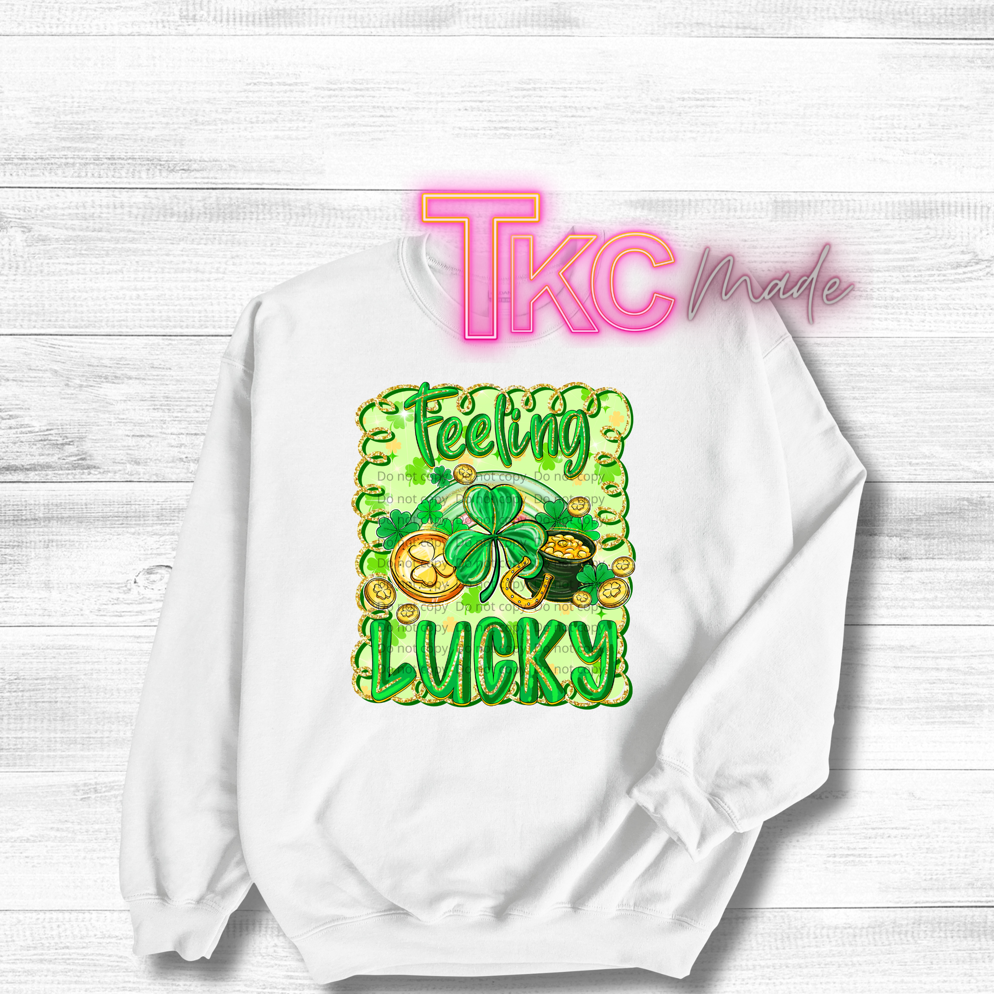 White sweatshirt with 'Feeling Lucky' design and 'TKC Made' text on a white background
