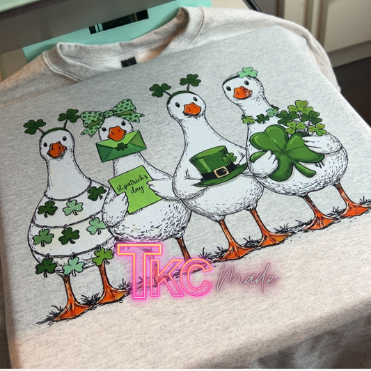 Gray sweatshirt with cartoon geese design and 'TKC made' branding.